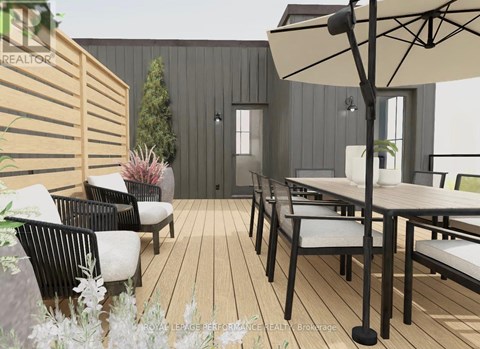 A modern outdoor seating area with a wooden floor and black metal chairs.