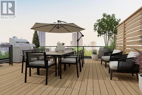 A patio with a table and chairs and a large umbrella.