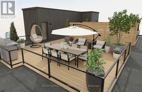 A modern outdoor seating area with a white umbrella and a wooden table.