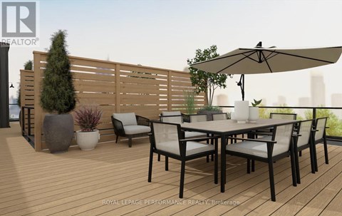 A wooden deck with a table and chairs and a large umbrella.