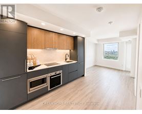 A modern kitchen with wooden cabinets and stainless steel appliances.
