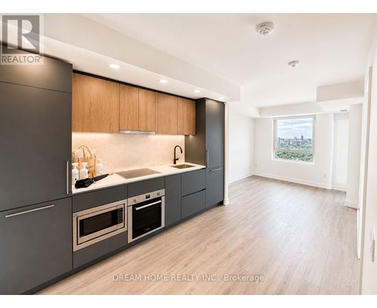 A modern kitchen with wooden cabinets and stainless steel appliances.