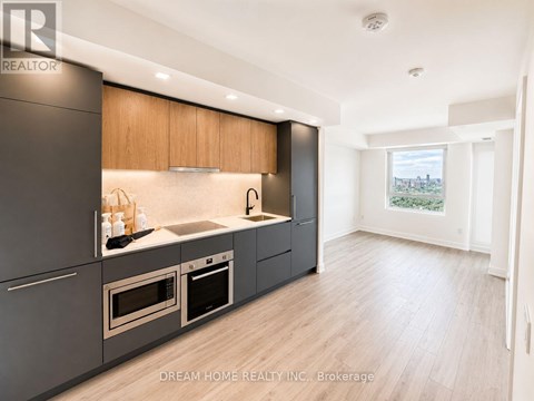 A modern kitchen with wooden cabinets and stainless steel appliances.