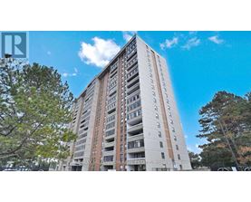 A tall residential building with balconies on each floor.