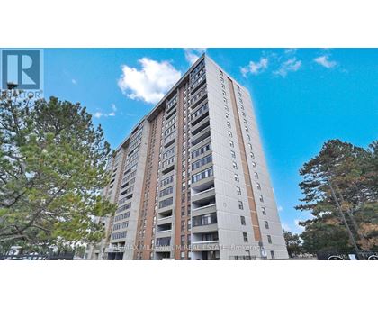 A tall residential building with balconies on each floor.