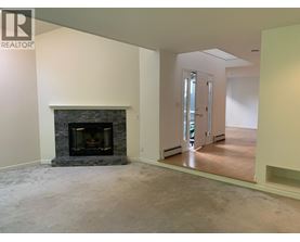A living room with a fireplace and a sliding glass door.