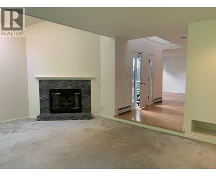 A living room with a fireplace and a sliding glass door.