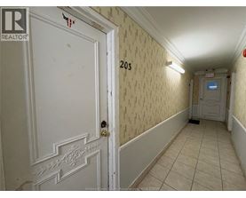 A hallway with a door on the left and a door on the right.