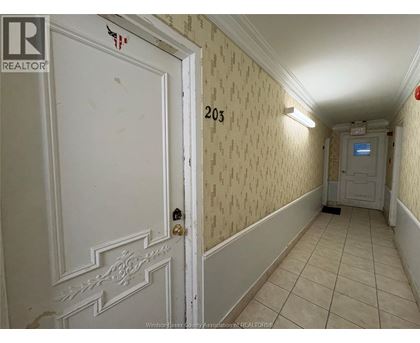 A hallway with a door on the left and a door on the right.
