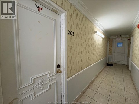 A hallway with a door on the left and a door on the right.