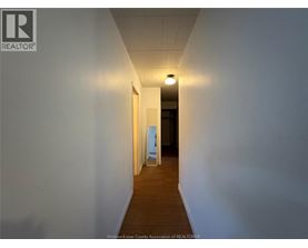 A long hallway with a light at the end.