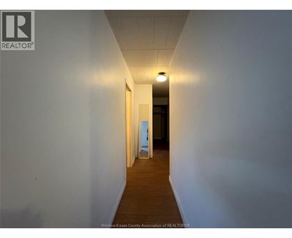 A long hallway with a light at the end.