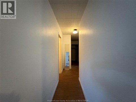 A long hallway with a light at the end.