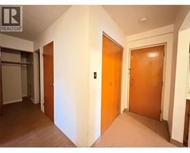 A hallway with two doors and a sign that says REALTOR.