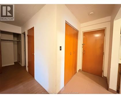 A hallway with two doors and a sign that says REALTOR.