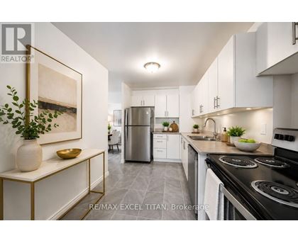 A modern kitchen with white cabinets and a black stove top.