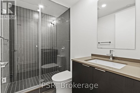 A bathroom with a walk-in shower and a sink.