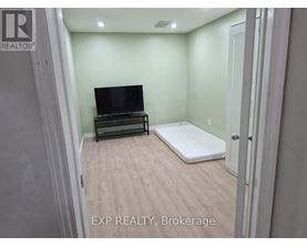 A bedroom with a bed and a television in it.