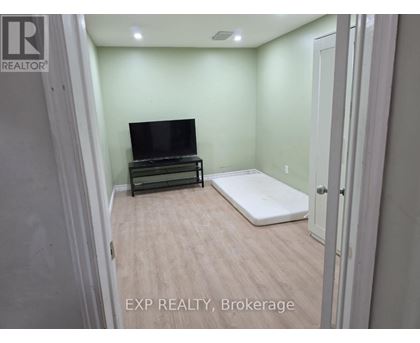 A bedroom with a bed and a television in it.