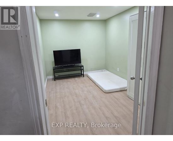 A bedroom with a bed and a television in it.