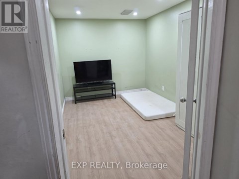 A bedroom with a bed and a television in it.