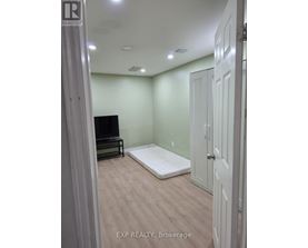 A bedroom with a bed, dresser, and closet.