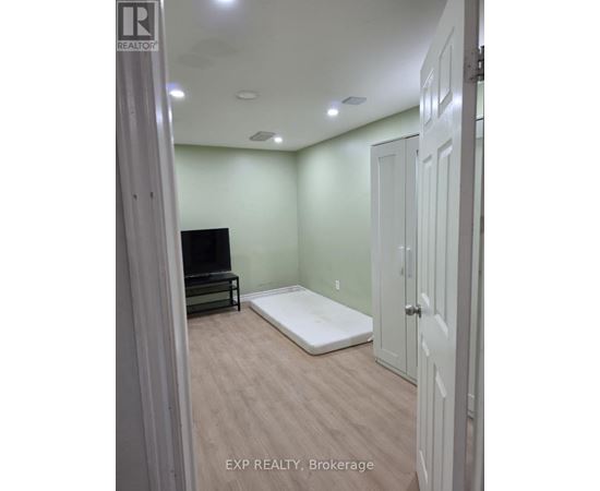 A bedroom with a bed, dresser, and closet.