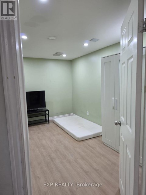A bedroom with a bed, dresser, and closet.