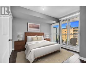 A bedroom with a large bed and a view of the city.