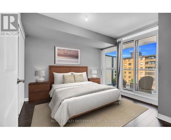 A bedroom with a large bed and a view of the city.