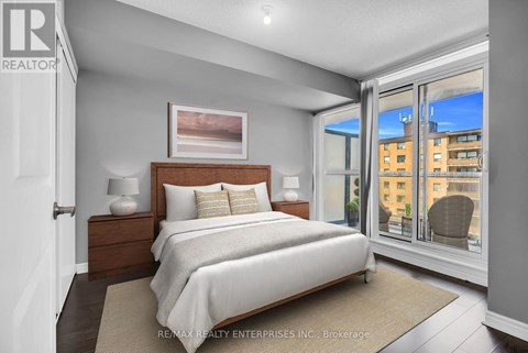 A bedroom with a large bed and a view of the city.