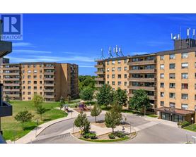 A realtor photo of a residential area with apartment buildings and a playground.