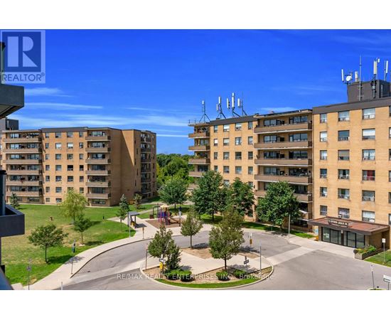 A realtor photo of a residential area with apartment buildings and a playground.