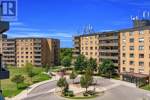A realtor photo of a residential area with apartment buildings and a playground.