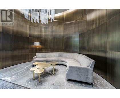 A modern living room with a grey sofa and a round coffee table.