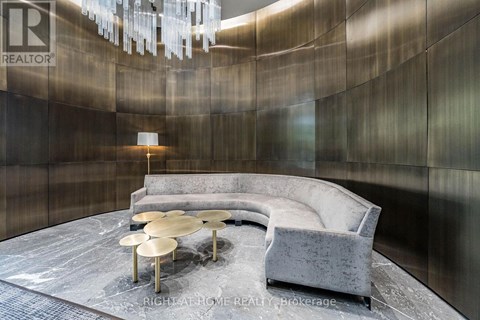 A modern living room with a grey sofa and a round coffee table.