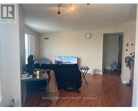 A living room with a couch, a television, and a desk with a computer.