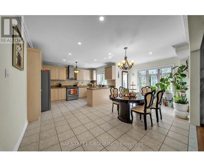 A spacious kitchen and dining area with a large table and chairs.