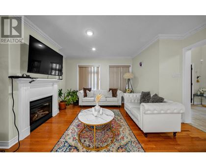 A living room with a fireplace and a white couch.