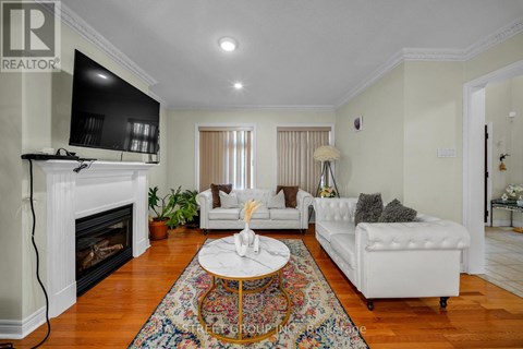 A living room with a fireplace and a white couch.