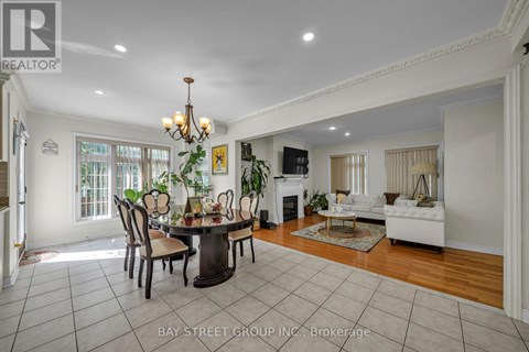 A dining room with a table set for six with a chandelier above it.