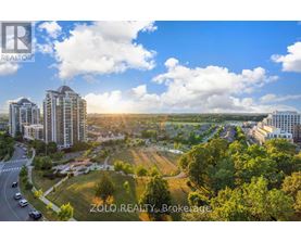 A real estate brokerage logo is displayed on a sunny day in a cityscape.