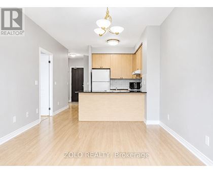 A well-lit kitchen area with wooden floors and a central island.