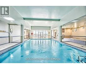 A large indoor swimming pool with a glass divider.