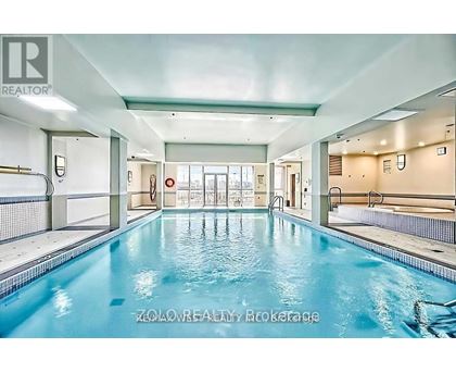 A large indoor swimming pool with a glass divider.