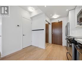 A kitchen area with a refrigerator, oven, and microwave.