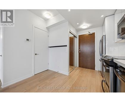 A kitchen area with a refrigerator, oven, and microwave.