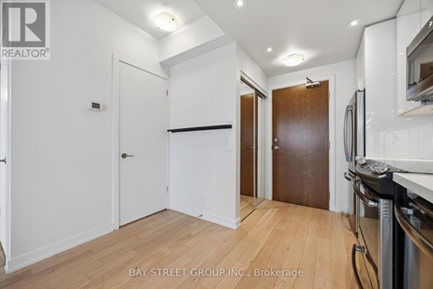 A kitchen area with a refrigerator, oven, and microwave.