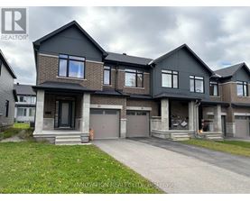 A modern two-story house with a garage is for sale.