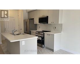 A kitchen with a sink, stove, and refrigerator.